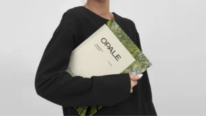 Woman holding an Opale book/magazine
